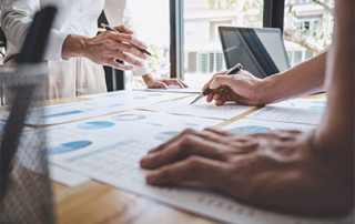 What to expect for a data warehouse project with Chateaux? Pictured: employees working out plans for a datawarehousing solution
