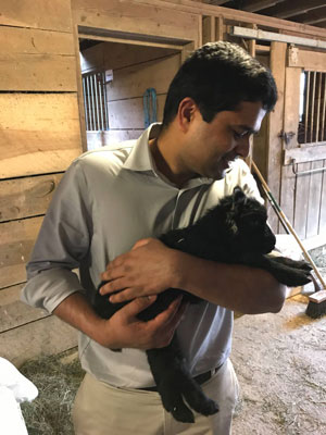 Vijay Rathna of Chateaux holding a baby goat